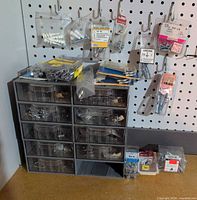 Front view of plastic drawer caddy with hardware packages and bags