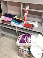 Overview of fabrics, fiberfill, HeatnBond adhesive, interfacing packages on shelving