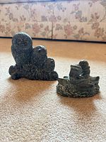 Both soapstone figurines side by side on carpet