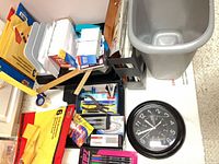 Grouped view of waste bin, clock, document holders and stationery