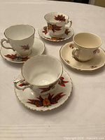 Group of four teacup and saucer sets showing different designs