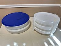 Overall view showing two pie takers on left, three pie stacker containers in rack on right