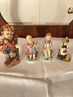 Group shot of four ceramic figurines