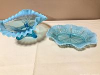 Both blue opalescent bowls side by side for size and pattern comparison