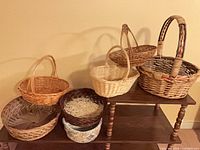 Group view of six wicker baskets displayed on tiered stand