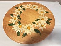 Top view of wooden lazy Susan showing full daisy wreath painting