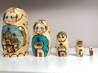 All five wooden nesting dolls lined up by size