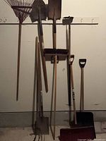 Group of yard tools leaning against wall