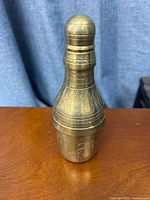 Whole brass bottle standing upright