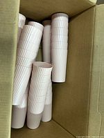 Open box with stacks of ribbed plastic cups