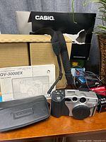 Camera, user guide, carry case, boxes, strap, cables visible