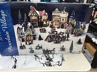 Front of retail box showing full porcelain village set and artwork