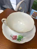 Teacup on saucer showing interior and floral design