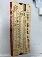 Full view of slide rule front showing scales and company information
