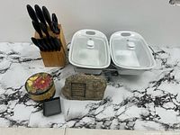 All items overview showing knife block, casseroles, plaque, tins and box