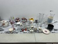 Full lot overview showing all assorted glassware, mugs, bowls, teapot and accessories