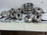 All cookware pieces arranged on table showing quantity and variety