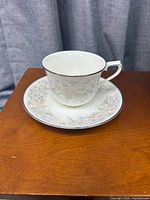 Cup and saucer set on wood surface
