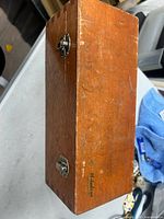 Closed hardwood case marked Mitutoyo showing exterior condition and latches