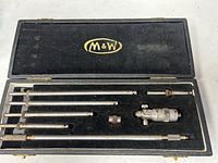 open case showing micrometer head, six rods, collar, wrench in flocked insert