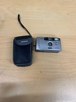 Front view of Nikon EF300 camera beside Nikon pouch