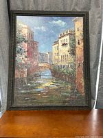 Front view of framed Venetian canal painting