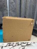 Sealed brown shipping box containing item