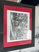 Full view of framed print with red mat and black frame