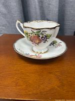 teacup on saucer showing front fruit design