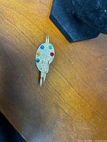 Front view showing rhinestone palette and brush