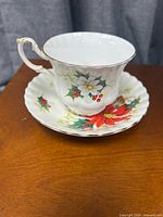 Teacup on saucer, full view showing pattern and gold trim