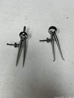 Both calipers front view showing size difference and adjustment screws