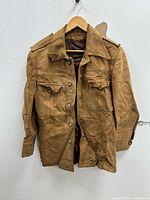 Front view of tan suede men’s jacket on hanger