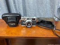 Camera front with lens and detached case pieces