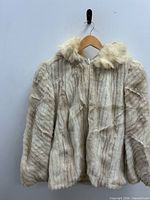 Full view of coat on hanger showing hood and zipper