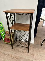 Full view of metal and wood wine rack table