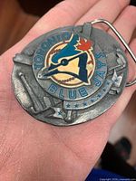 Front of buckle showing Blue Jays logo, bats, CN Tower
