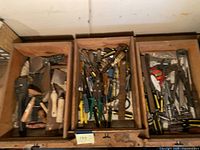 Overview of three drawers filled with assorted hand tools
