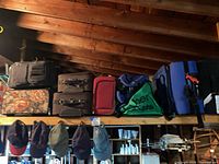 All luggage and bags stored on rafter shelf