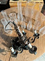 Chandelier and group of 12 glass shades on table