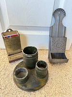 Lot overview showing both wall match holders and green painted multi-cup stand