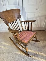 Full view of oak rocking chair with cushion