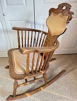 Left side view showing spindle arms, legs, runners, upholstery