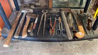 Overhead group shot of all ten antique and vintage hand tools on bench