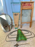 Group shot of washboard, drying rack, scoop, utensil