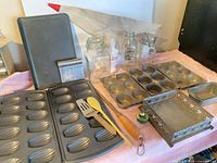 Group shot showing bakeware, utensils, glass containers, grout bag and napkin holder