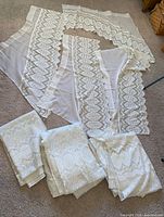 Top view of full lot showing valances, lace panels, jacquard panels