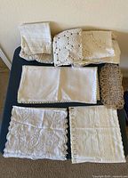 Grouped view of folded and laid-out vintage linens