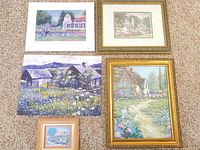 All five artworks laid out on carpet