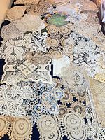 Wide view showing large assortment of lace pieces spread out